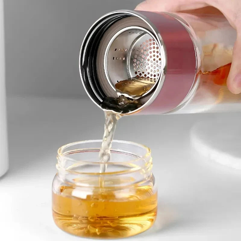 Clear storage bottle with perforated stainless cap, pouring amber liquid