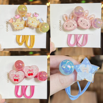 Assorted elastic hair ties with crown, bunny, heart, and star charms on cards