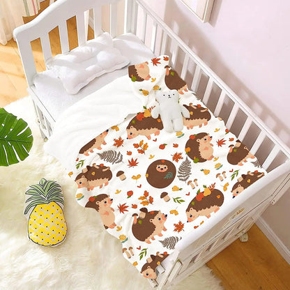Hedgehog and autumn leaf blanket on crib bedding, white with brown hedgehog pattern