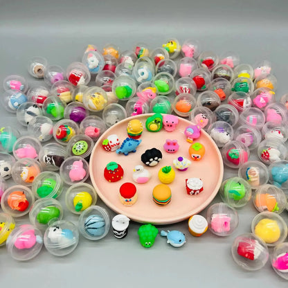 Transparent capsule eggs around a round tray of small colorful toy charms