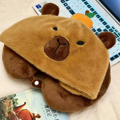 Capybara plush neck pillow hat with tan face, brown nose, and small chin button.