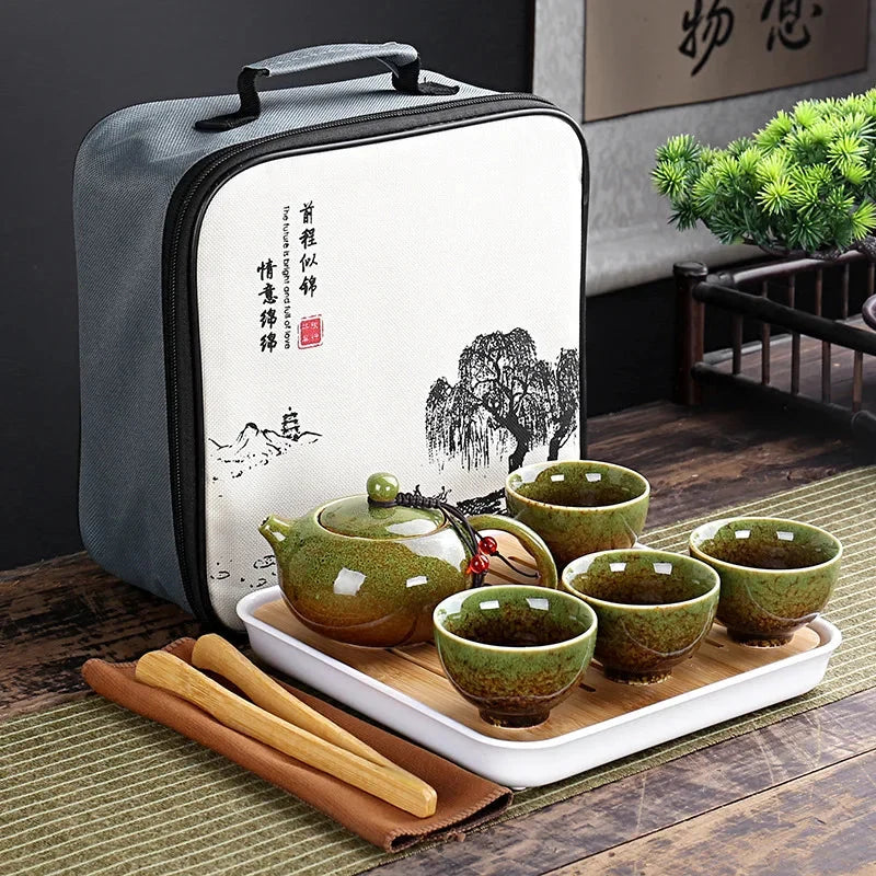 Portable Chinese kung fu tea set in gray carrying bag with green teapot, cups, and tray