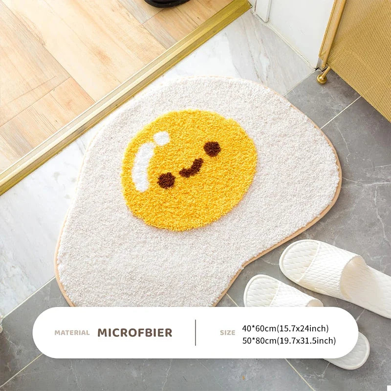 Cute egg bath mat rug with yellow smiling egg face, oval shape near slippers