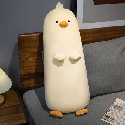 Long white chick plush pillow with embroidered face, tiny wing details, and feet