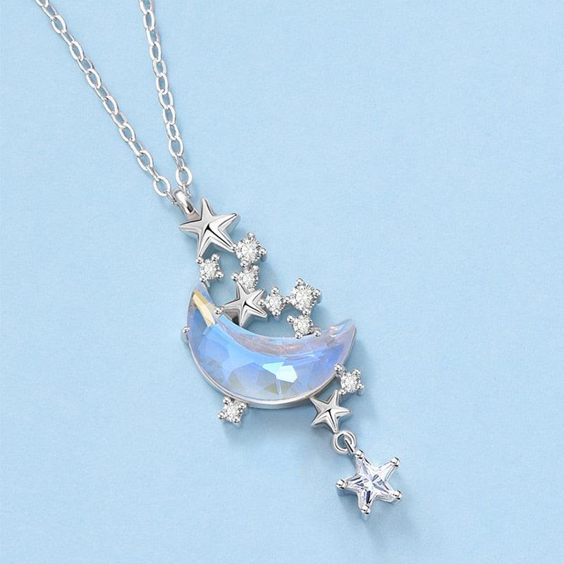 Blue iridescent glazed crescent moon pendant necklace with star charms and crystal stones