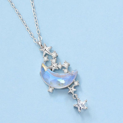 Blue iridescent glazed crescent moon pendant necklace with star charms and crystal stones
