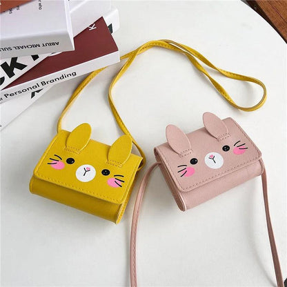 Yellow and blush pink bunny crossbody bags with stitched faces and adjustable strap