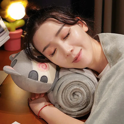 Light grey cat pillow blanket with rolled blanket and stitched cat face detail