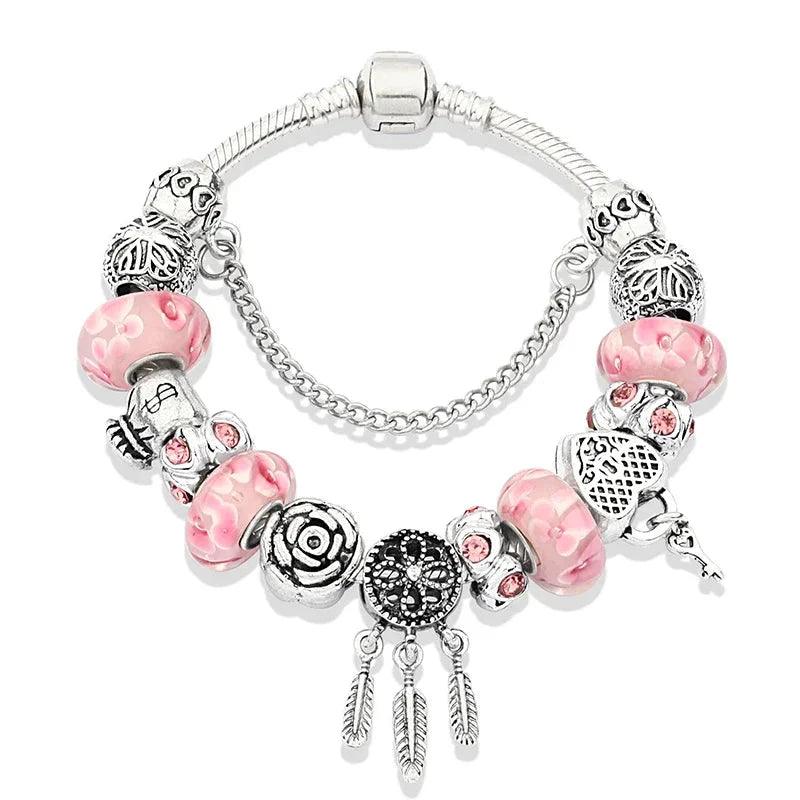 Pink charm bracelet with silver beads; heart, paw, and dangling charms