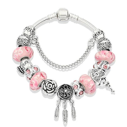 Pink charm bracelet with silver beads; heart, paw, and dangling charms