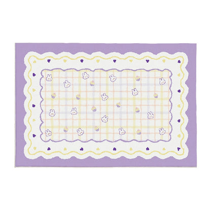 Purple plush area rug with scalloped border, light checker grid, and small bunny faces