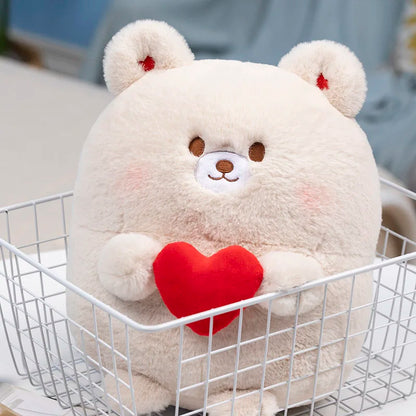 Cream bear plush with red heart, standing in a white wire basket.