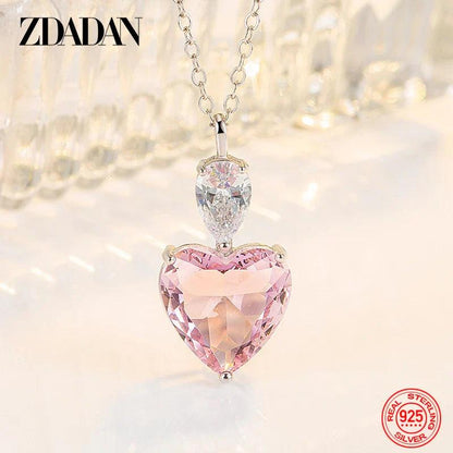 Pink heart pendant necklace with clear heart centerpiece on silver-tone chain