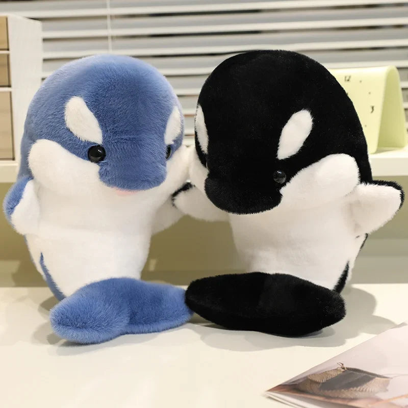 Blue and black dolphin plush toys, seated with white bellies and flipper details.