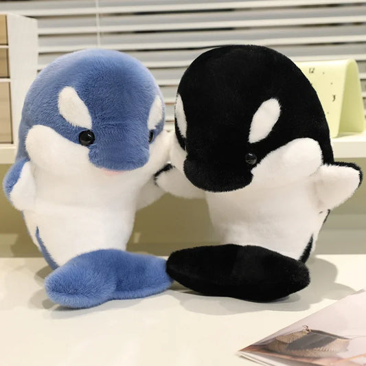 Blue and black dolphin plush toys, seated with white bellies and flipper details.