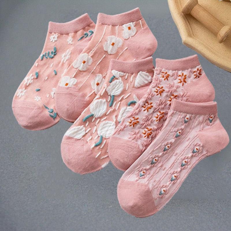 Floral embroidered socks in pink with white flowers and orange accents, ribbed ankle cuffs