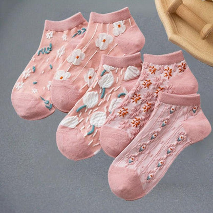 Floral embroidered socks in pink with white flowers and orange accents, ribbed ankle cuffs