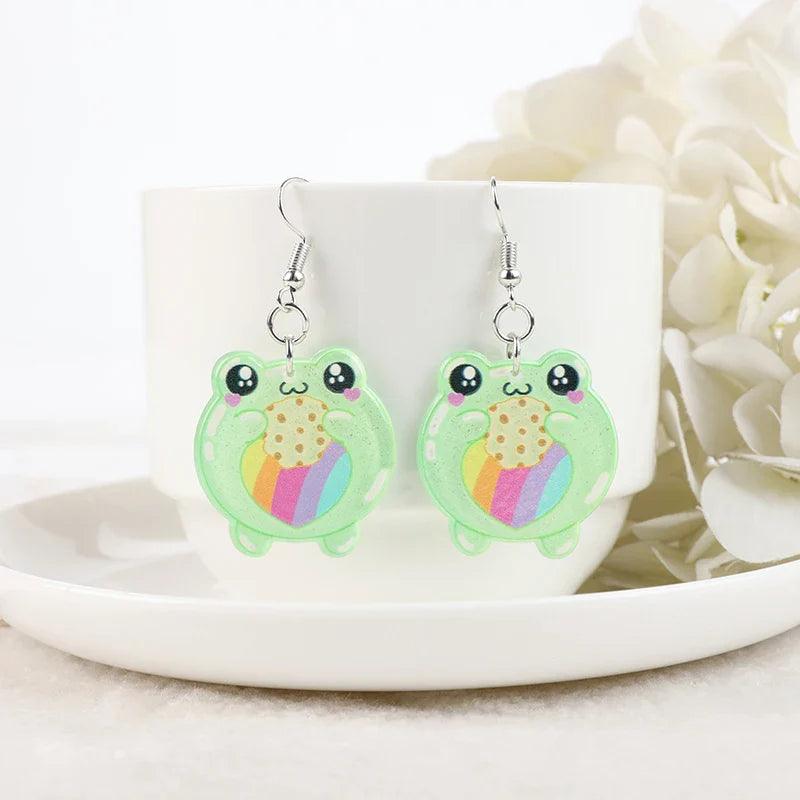 Frog acrylic earrings with green frog charms showing colorful belly-heart details and silver hooks