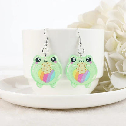 Frog acrylic earrings with green frog charms showing colorful belly-heart details and silver hooks