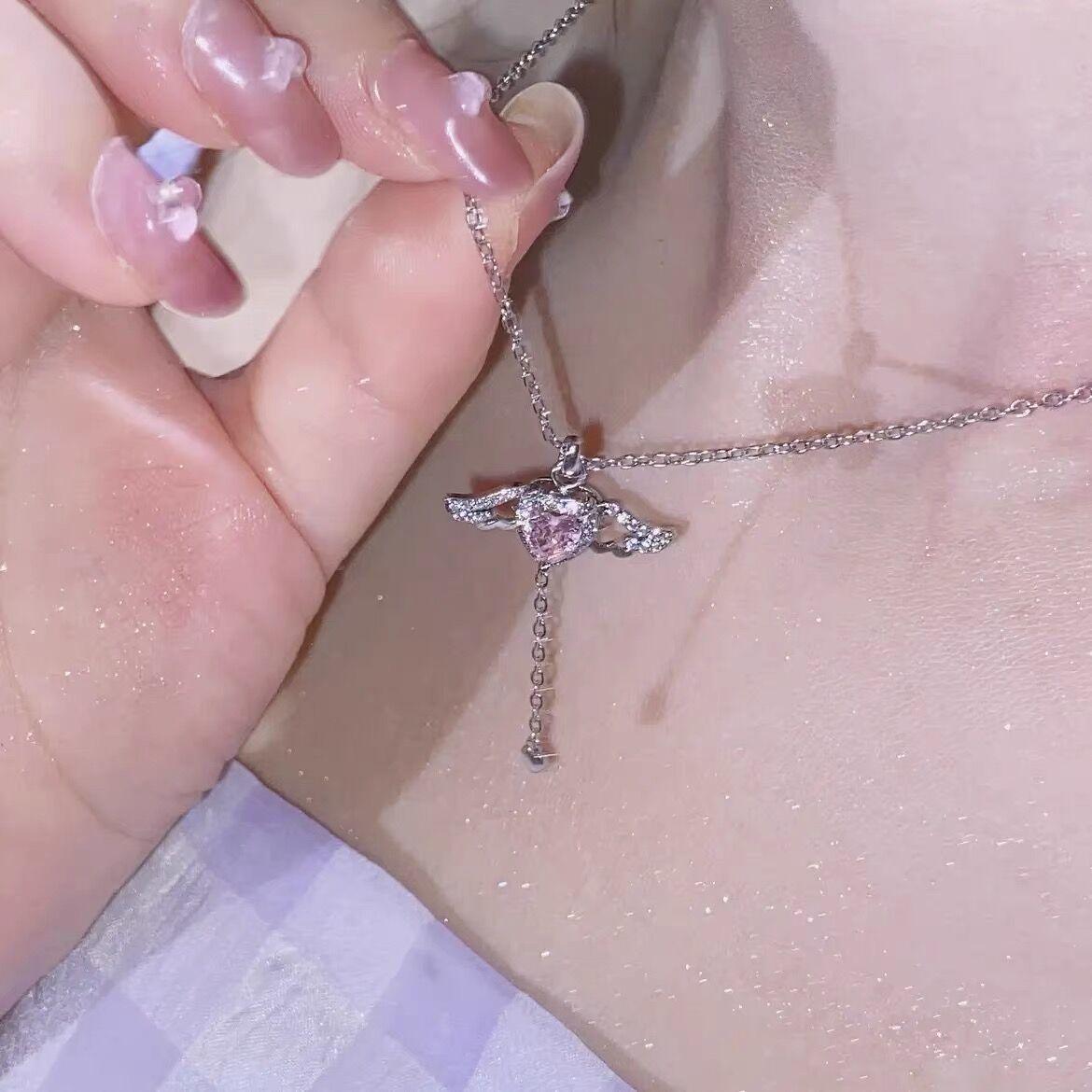 Silver-tone pink crystal heart angel wings pendant necklace, close-up