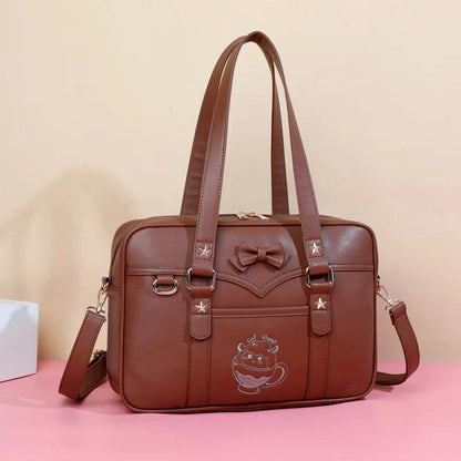 Kawaii messenger bag in brown with front logo patch, bow accent, and dual top handles