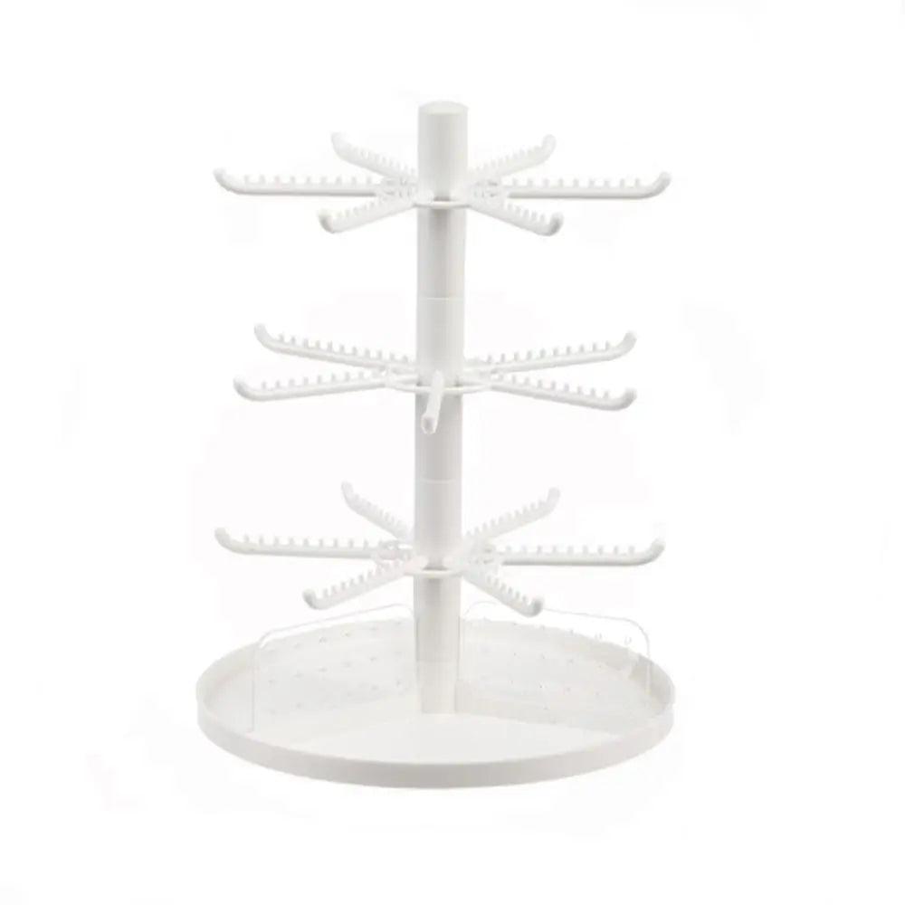 White rotating earring display stand with three tiers of hook arms and clear base