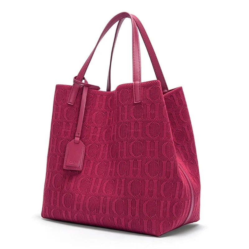 Magenta knitted tote bag with embossed CHCH pattern, dual top handles, hanging tag.