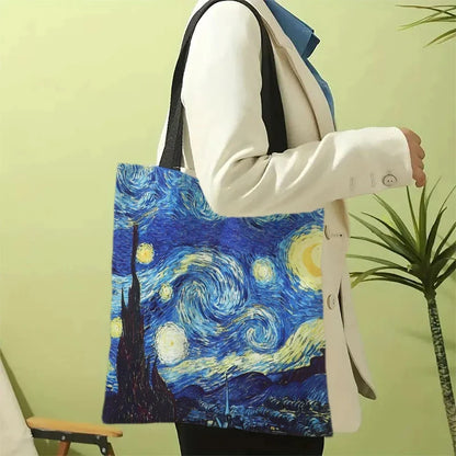 Blue canvas tote bag with Starry Night print and black shoulder handles