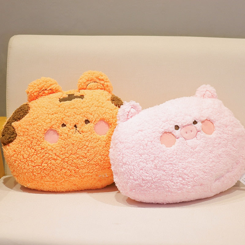 Two animal plush cushion pillows: orange bear and pink pig, side view