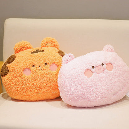 Two animal plush cushion pillows: orange bear and pink pig, side view