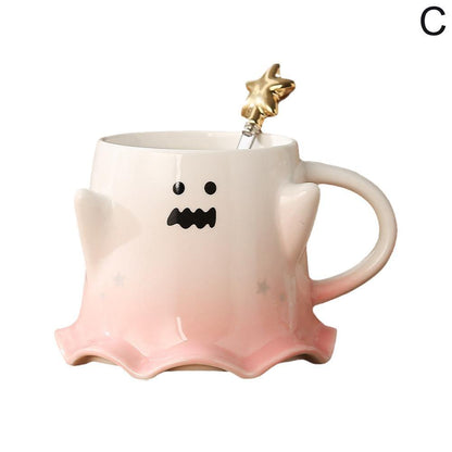 Ghost face mug with wavy mouth and gold star stirrer, pastel pink base and side handle