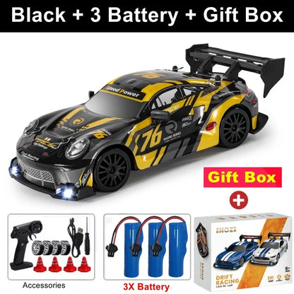 Black RC drift racing car with yellow graphics, black rear wing, 4x4 off-road style