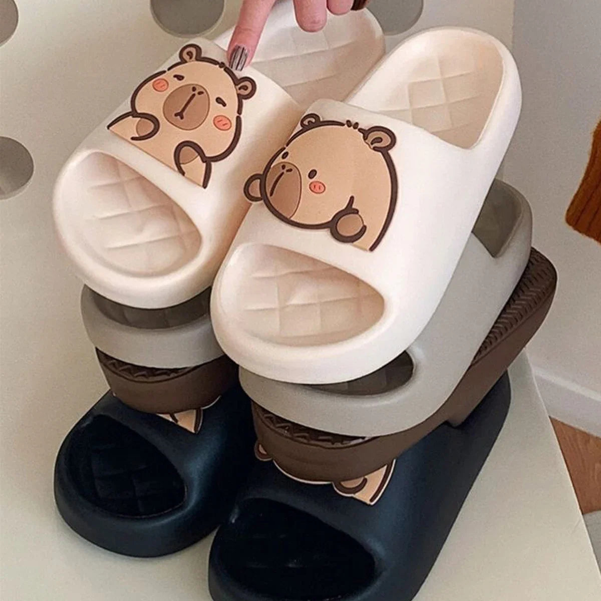Capybara slide sandals set: white and black pairs with cartoon face details.