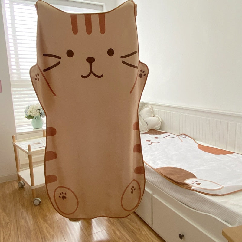 Cat flannel blanket in tan with large cat face print and paw accents