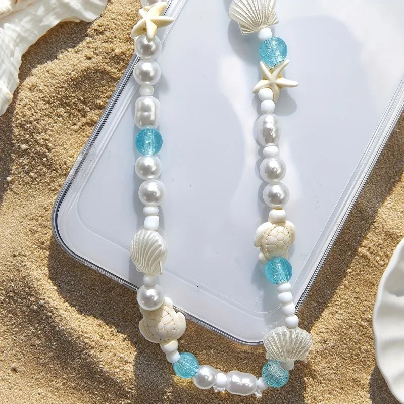 Shell and pearl phone charm bracelet with blue accents and starfish centerpiece beads