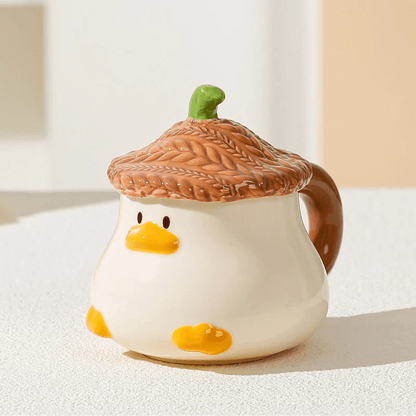 Duck-shaped ceramic mug with brown textured lid, orange beak face, and side handle
