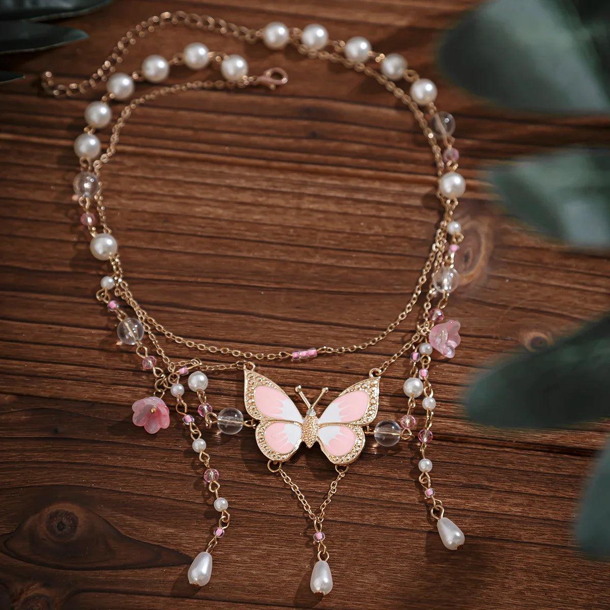 Butterfly imitation pearl multi-layer necklace with pink and white pearls and dangling charms