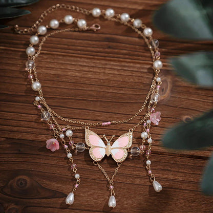 Butterfly imitation pearl multi-layer necklace with pink and white pearls and dangling charms