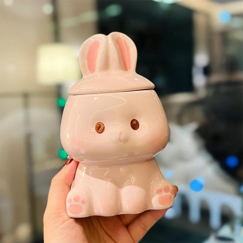 Ceramic bunny-lid mug, white body with pink ears, face details, paw-print base