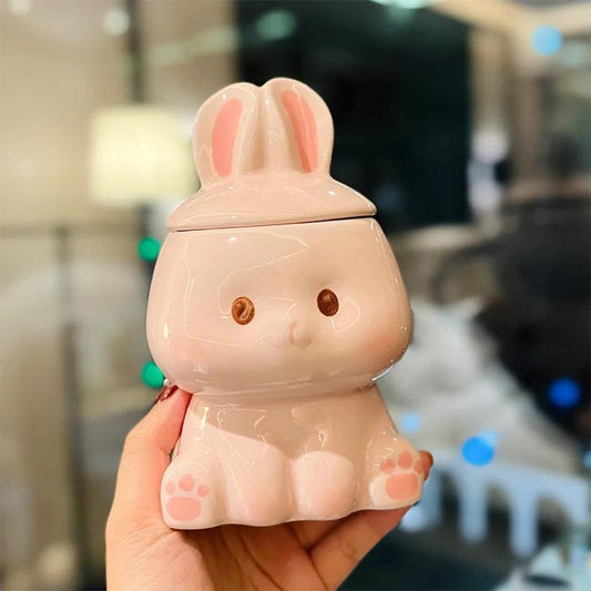 Ceramic bunny-lid mug, white body with pink ears, face details, paw-print base