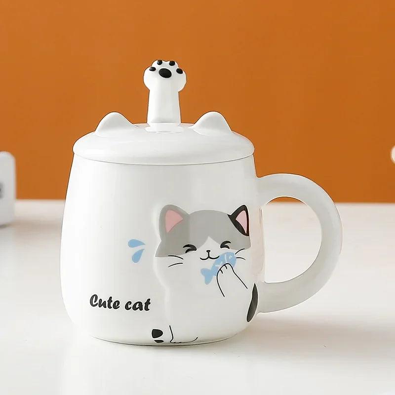 White cat face lidded mug with blue bow, standing on a flat surface