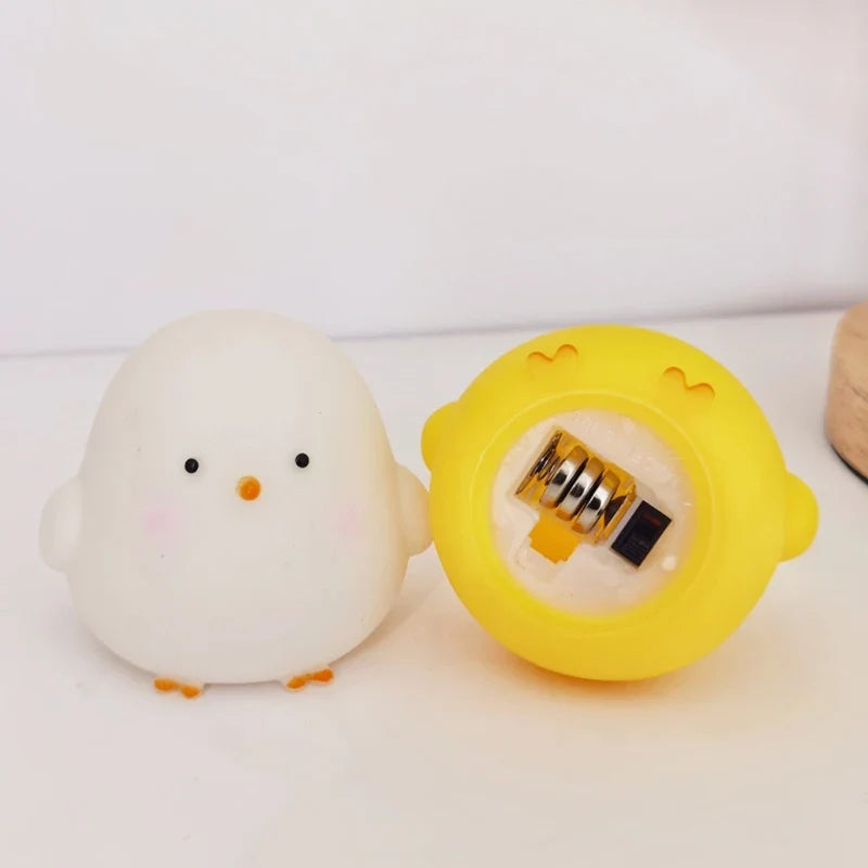 Silicone chick LED night lights in white and yellow; open base shows battery compartment