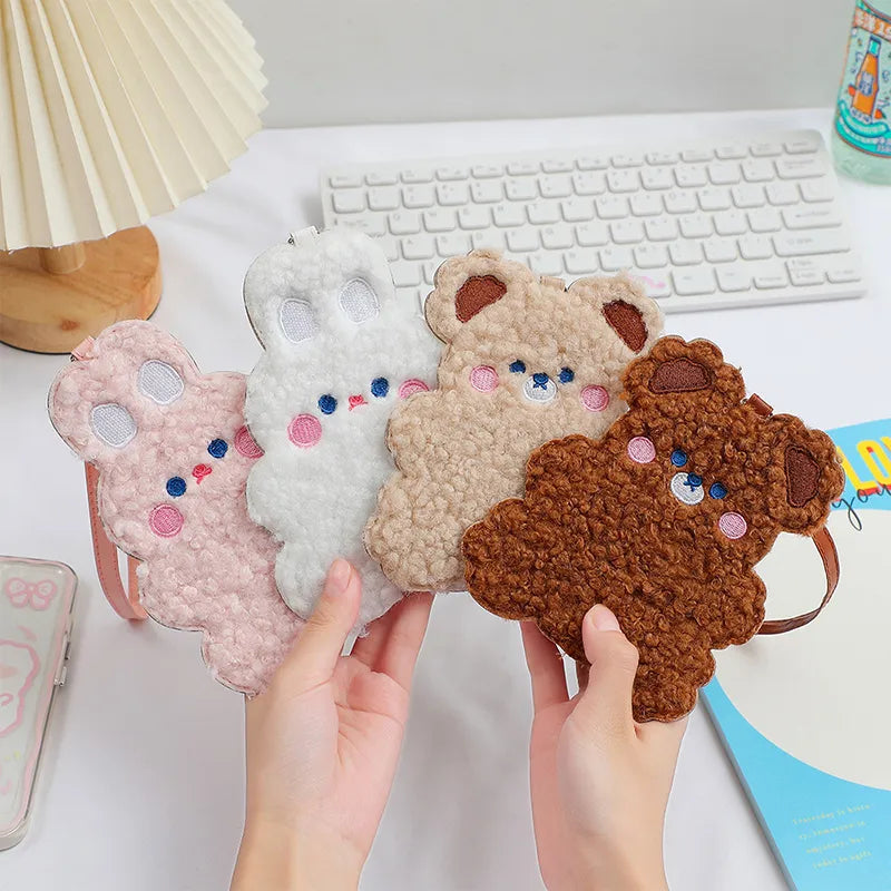 Plush animal photo card sleeves set in white, pink, beige, and brown, held in hands