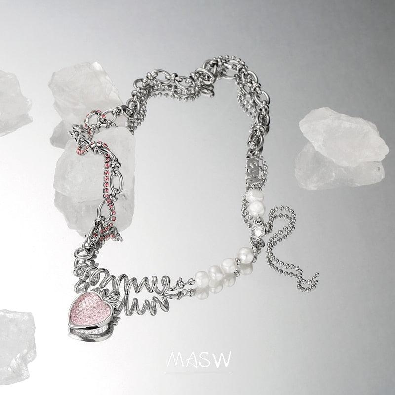 Strawberry pendant necklace showing pink heart charm, mixed link chain, and pearl accents