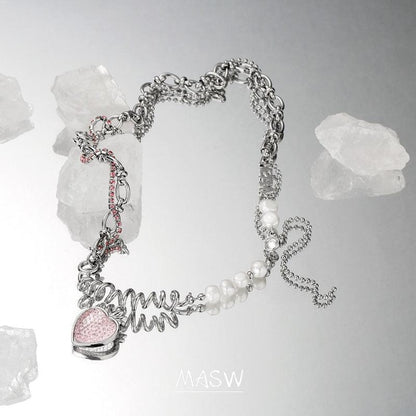 Strawberry pendant necklace showing pink heart charm, mixed link chain, and pearl accents