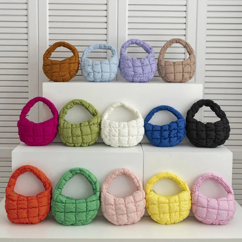 Quilted mini puffer circle tote bags with short handles, assorted colors on display