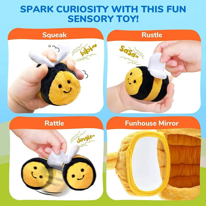 Plush bee toy with white wings and rattle elements, shown as squeak and rustle play