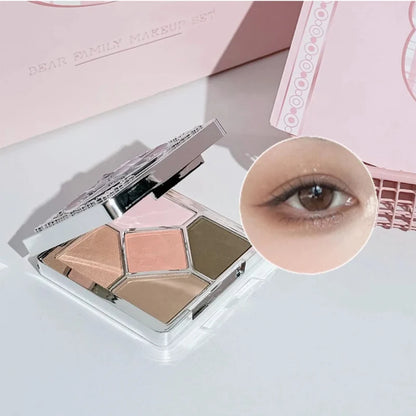 Open four-pan eyeshadow palette next to close-up makeup application on face