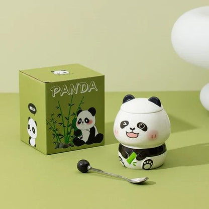 Ceramic panda mug with lid and spoon on display; white mug with black belt and panda design