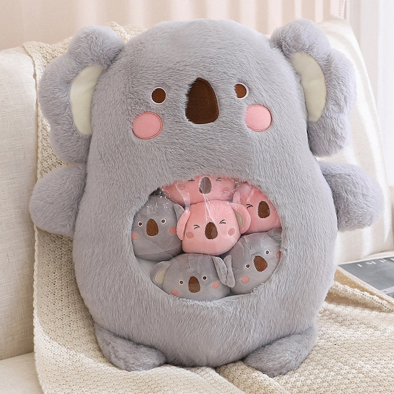 Plush animal shaped pillow in light grey, close-up koala face with embroidered paw circle